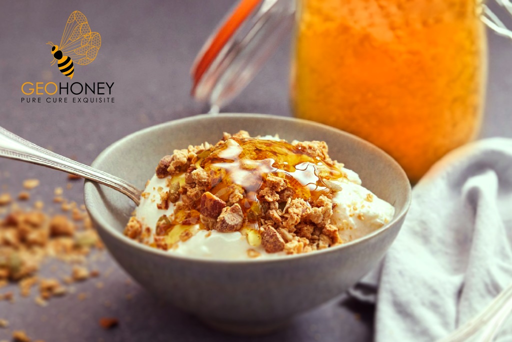 Honey Peanut Butter Granola in a bowl with rolled oats, peanuts, and a drizzle of honey and peanut butter mixture.