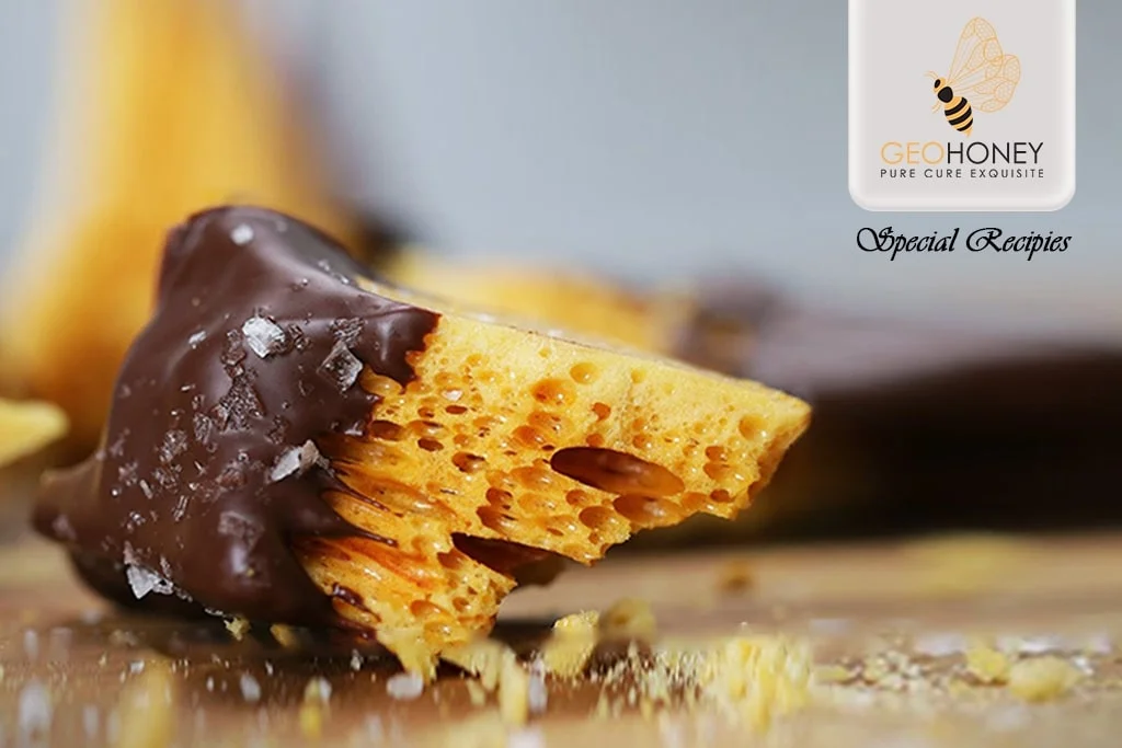 Homemade honeycomb toffee with chopped honeycomb pieces on top.